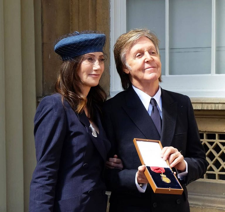 Paul McCartney and Nancy Shevell with his Companion of Honour award, 4 May 2018