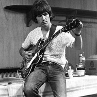 George-Harrison-and-his-guitar.jpg