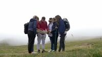 videoblocks-lost-group-of-teenage-friends-checking-the-map-trying-to-find-out-the-right-way-on-foggy-mountain-top_blif4ezof_thumbnail-full01.png