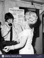 beatles-files-1964-paul-mccartney-on-the-phone-standing-beside-zsa-b5035x.jpg