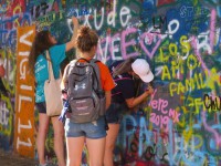 Tourists-writing-on-the-Lennon-Wall-in-summer-2019.-via-Raymond-Johnston.jpg